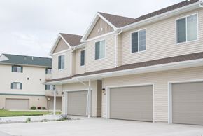 West Fargo townhouse for rent - a house with two garage doors on the side of it