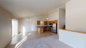 West Fargo townhouse for rent - the living room and kitchen of an empty house with white walls