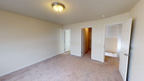 West Fargo townhouse for rent - a bedroom with a carpeted floor and a door to a closet