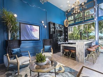 San Diego apartment for rent - A blue living room with a white chair and a coffee table.