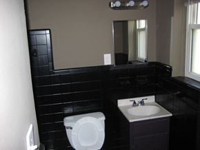 St. Louis apartment for rent - a bathroom with a toilet and a sink and a mirror
