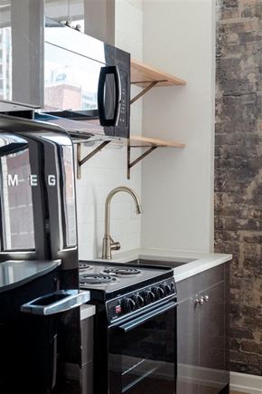 Chicago apartment for rent - a small kitchen with a stove and a microwave