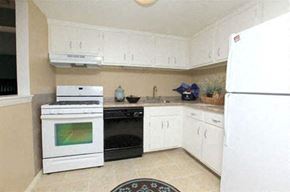 Warwick apartment for rent - a white kitchen with a stove and a refrigerator