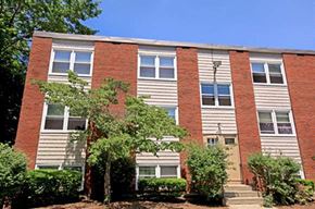 Riverside apartment for rent - a brick building with trees in front of it