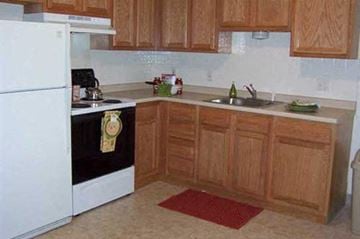Riverside apartment for rent - a kitchen with a stove refrigerator and a sink
