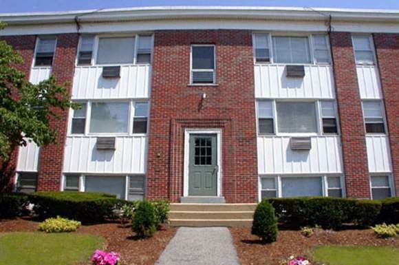 Cranston apartment for rent - the front of a brick building with a green door