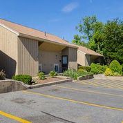 Warwick apartment for rent - a church building with a parking lot and trees