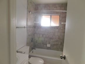 San Diego apartment for rent - a bathroom with a tub and a toilet and a window