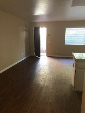 San Diego apartment for rent - A room with a wooden floor and a white cabinet.