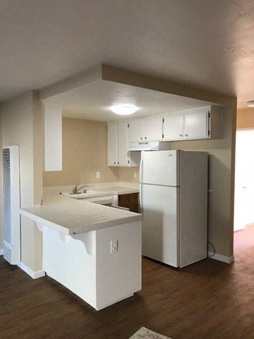 San Diego apartment for rent - A kitchen with white appliances and cabinets.