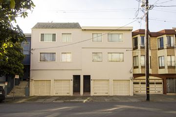 San Francisco apartment for rent - A two-story building with a garage door is in the foreground.