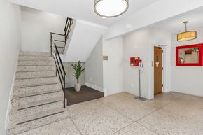 San Francisco apartment for rent - the landing lobby of a building with a staircase and a potted plant