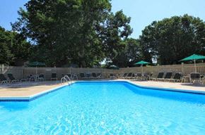 Coventry apartment for rent - a large swimming pool with chairs around it