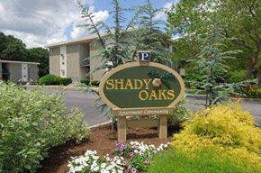 West Warwick apartment for rent - a sign for shady oaks in front of a building