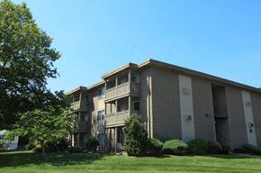 West Warwick apartment for rent - an apartment building with a green lawn and trees