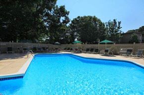 West Warwick apartment for rent - a large blue swimming pool with chairs around it