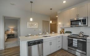 East Walpole apartment for rent - a kitchen with white cabinets and stainless steel appliances