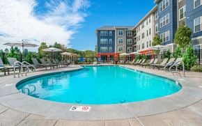 East Walpole apartment for rent - a swimming pool with an apartment building in the background