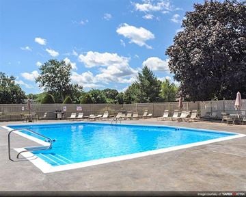 Warwick apartment for rent - a blue swimming pool with chairs around it
