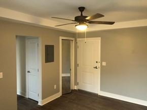 Detroit apartment for rent - a living room with a ceiling fan and a door
