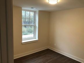 Detroit apartment for rent - a empty room with a window and wooden floors