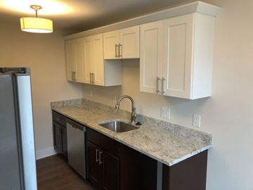 Detroit apartment for rent - a kitchen with white cabinets and a sink
