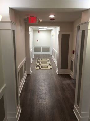 Detroit apartment for rent - a hallway with wooden floors and a red light on the ceiling