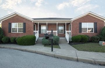 Jeffersonville house for rent - A red brick house with a white porch and mailbox.