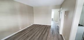 Sacramento apartment for rent - A room with wooden flooring and white walls.