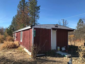 Hayfork apartment for rent - a red building with a white roof in the dirt