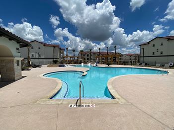 Swimming pool with curved design and surrounding deck