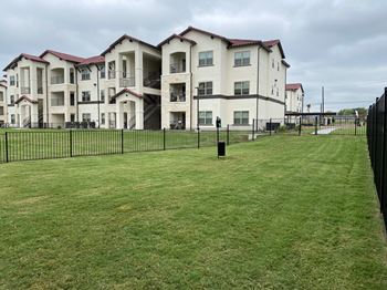 Three story apartment buildings with manicured lawn