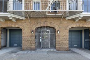 San Francisco apartment for rent - A brick building with a metal gate in the center.