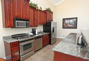 Burton apartment for rent - a kitchen with stainless steel appliances and wooden cabinets
