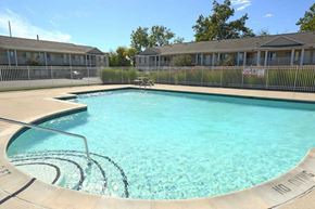 Burton apartment for rent - a large swimming pool in front of a house