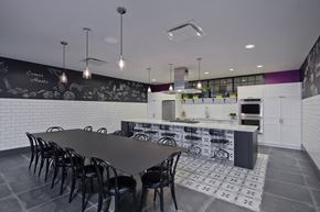 Chicago apartment for rent - A black and white kitchen with a long table and chairs.