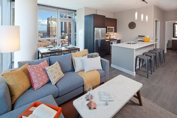 Chicago apartment for rent - A modern living room with a grey couch and a coffee table.