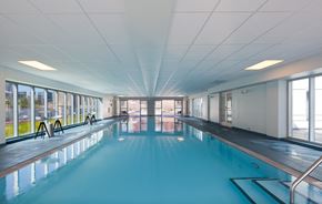 Chicago apartment for rent - A large indoor swimming pool with a blue tinted water.