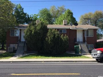 West Valley City apartment for rent - A red brick house with a white door and windows.