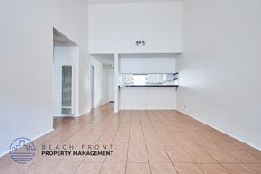 Long Beach apartment for rent - A large empty room with a tiled floor and white walls.