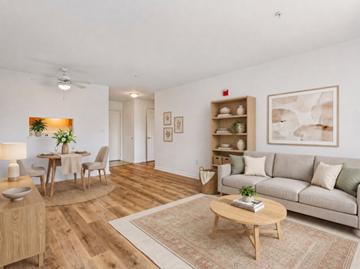 Gwynn Oak apartment for rent - A living room with a couch, a coffee table, and a dining table with chairs.