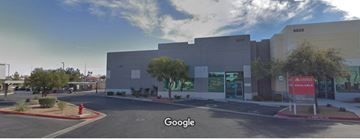 Las Vegas apartment for rent - A street view of a building with a red sign in front.