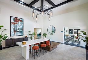 Peoria apartment for rent - A modern dining area with a white table and orange chairs.
