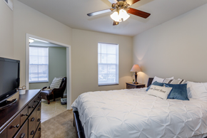 Lawrence apartment for rent - a bedroom with a large bed and a ceiling fan