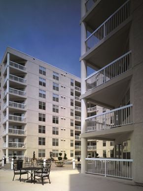 Baltimore apartment for rent - a large apartment building with tables and chairs in a courtyard