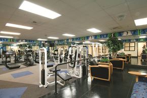 Baltimore apartment for rent - a gym with a lot of machines and chairs in it