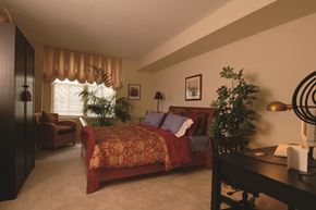 Baltimore apartment for rent - a bedroom with a bed and a desk and a window