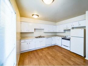 Houston apartment for rent - an empty kitchen with white cabinets and white appliances