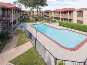 Houston apartment for rent - a resort style pool with a fence around it