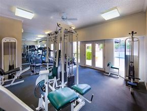 Dallas apartment for rent - a gym with weights and other equipment in a room with windows